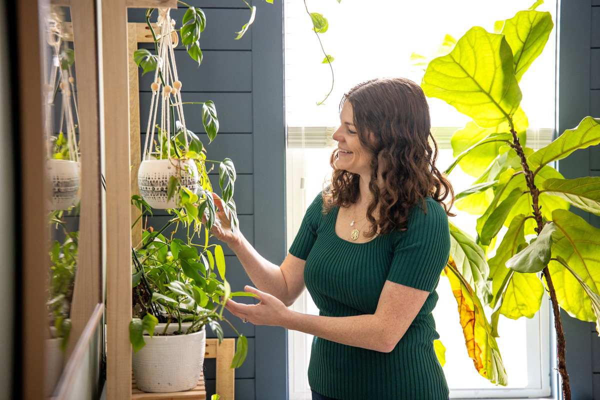 woman admiring her houseplants